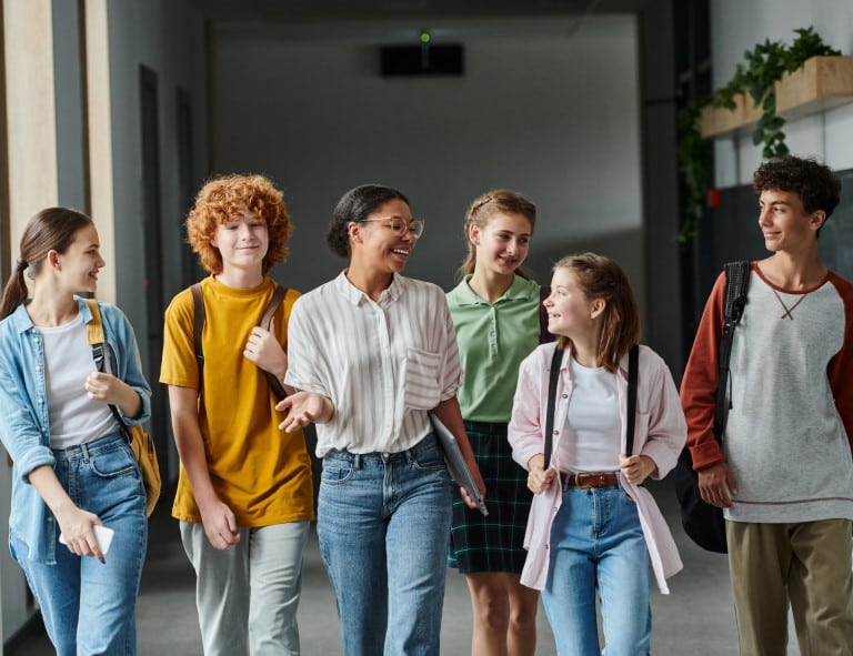 happy students walking in school